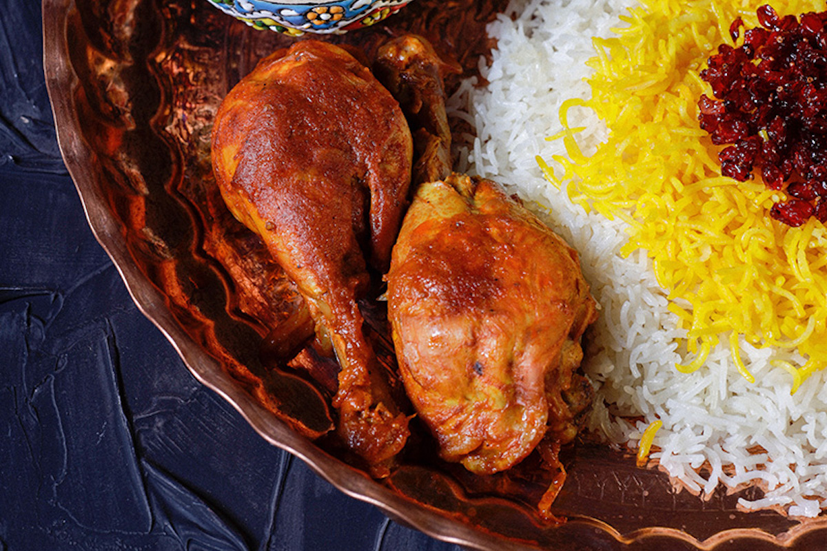 A dish of saffron chicken and rice.